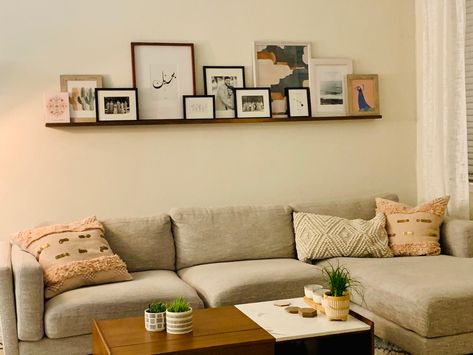 Floating Shelf Over Sectional, Floating Shelf Photo Gallery, Floating Shelf With Picture Frames, Gallery Shelf Ideas, Floating Picture Shelf Above Couch, Floating Shelf Picture Wall, Long Floating Shelf Above Couch, Above Couch Floating Shelves, Hanging Shelf Above Couch