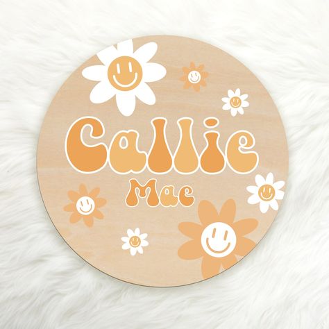 A sweet and adorable addition for your nursery, this personalized round wood sign will hold your child's name for generations. It's made from hardwood, with a happy daisy floral design in shades of yellow, personalized with your child's name. Perfect for baby birth announcements, pregnancy announcements or an adorable photo prop when babe makes their grand entrance into the world! PRODUCT INFO: Wood rounds are made of natural wood. 0.1 inch/0.25 cm in thick. Printed on wood using high-quality UV Painted Name Signs, Baby Birth Announcements, Hippie Names, Cheerful Daisy, Groovy Daisy, Happy Daisy, Round Wood Sign, Pregnancy Announcements, Baby Birth Announcement