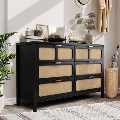 Crafted with high-quality Ratten and MDF, this durable double dresser features 6 spacious drawers, The metal handles are durable. This multi-drawer storage dresser is a space-saving clothes organizer for bedrooms, but also acts as an excellent storage cabinet in your living room or entryway. The flat top can place a TV stand for lamps, electronics, picture frames, and more Color: Black | Bay Isle Home™ Bequia 6 - Drawer Dresser Wood / Wicker / Rattan in Black, Size 29.7 H x 47.2 W x 15.7 D in | Black Cane Dresser, Black And Rattan Dresser, Dresser With Wicker Drawers, Black And Rattan Nightstand, Black Rattan Dresser, Black Woven Dresser, Rattan Room, Black Rattan Chest Of Drawers, Boho Rooms