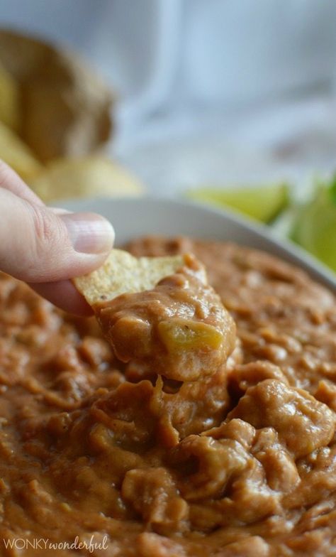 A simple game day appetizer that is sure to be a hit!  This Homemade Bean Dip Recipe is a flavorful blend of pinto beans, green chilies, spices and lots of cheese! Homemade Bean Dip, Bean Dip Recipe, Green Chilis, Bean Dip Recipes, Homemade Beans, Pinto Bean, Snack Dip, Bean Dip, Pinto Beans