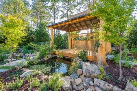 This peaceful Zen garden features a pavilion of bamboo and white cedar for introspective moments gazing into the reflecting pond. The pavilion can be reached by crossing an attractive wooden bridge that rises over a small stream running from the pond. Jazz Clubs, Outdoor Water Feature, Building A Pergola, Backyard Water Feature, Asian Garden, Backyard Pergola, Backyard Retreat, Fish Ponds, Diy Pergola