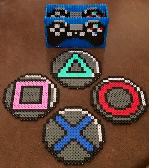 Gamers out there will be fans of Jason‏'s Playstation controller coasters to rest his cup of tea while he's video-gaming or Hama-Beading! (Twitter: @Daywalker73) Playstation Perler Beads, Perler Beads Gaming, Peeler Bead Coaster, Hama Bead Coasters Ideas, Pyssla Coaster, Gamer Perler Beads, Perler Beads Video Games, Perler Bead Games, Video Game Perler Beads