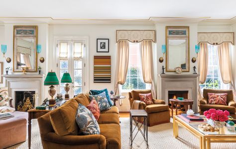 A double parlor in size, the living room’s camel-colored sofa and club chairs, all made by DFM, wear Holland & Sherry mohair velvet. A striped James Betts painting holds its own among pairs of mirrors made from architectural panels, blue Anglo-Indian sconces and antique Coalport vases-turned-lamps from Seventh Heaven Antiques. The rug is by Stark. Double Parlor Living Room, Mohair Sofa, Double Parlor, Parlor Living Room, Colored Sofa, Wool Stair Runner, Savannah Style, Villa Lagoon Tile, Sleek Coffee Table