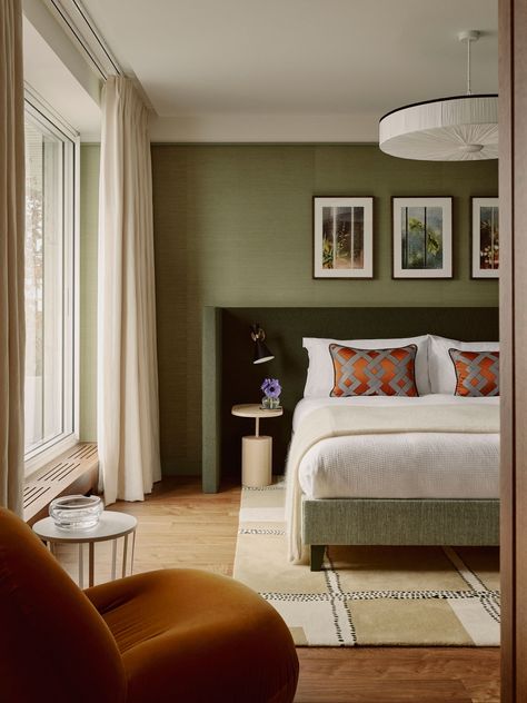 The primary bedroom at our Paris apartment, in fresh green and contrasting rust tones. Eclectic Luxury Bedroom, Sage Green Primary Bedroom, Green Mid Century Bedroom, Green Hotel Room, Deep Green Bedroom, Green Bed Frame, Pop Of Color Bedroom, Airbnb Bedroom Ideas, Modern Green Bedroom