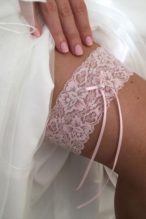 Our Purity wedding garter is perfect for the understated bride. A simple lace garter handmade from a single layer of delicate pale pink lace, finished with a narrow satin ribbon bow adorned with a single ivory pearl. A gorgeous wedding gift for the classic bride, you can't go wrong with this pretty design! Wedding Lengire, Bride Garter, Wedding Garter Lace, Pearl Hair Vine, Classic Bride, Bridal Cover Up, Bridal Handbags, Satin Ribbon Bow, Lace Garter