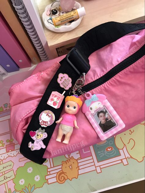 medium crescent baggu dyed pink. sonny angel keychain by me. my melody keychain from morning glory. mental health pin from a small shop. strawberry milk pin from hot topic. hello kitty pin from san francisco. bear pin from disneyland. #pink #baggu #disney #pinkaesthetic #kpop #straykids #skz #bangchan Baggu Charms, Baggu Aesthetic Girl, Baggu Crescent, Baggu Hello Kitty, Baggu Medium Crescent Bag Outfit, Baggu Decorated, Baggu Crescent Bag Decorated, Baggu Medium Crescent Bag, Baggu Keychain