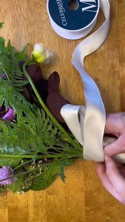 How to wrap a bridal bouquet in ribbon tutorial!If you’re planning to DIY your wedding flowers, then you might need to know how to put ribbon on your bridal ... How To Make Bouquets For Wedding, Ribbon Bouquet Wrap, Diy Flower Bouquet Wrapping Tutorial, Tie Ribbon On Bouquet, Bridal Bouquet Ribbon Wrap, Wrapping A Bouquet With Ribbon, How To Tie Ribbon On Bouquet, How To Make A Bridal Bouquet Tutorials, How To Wrap A Bouquet With Ribbon