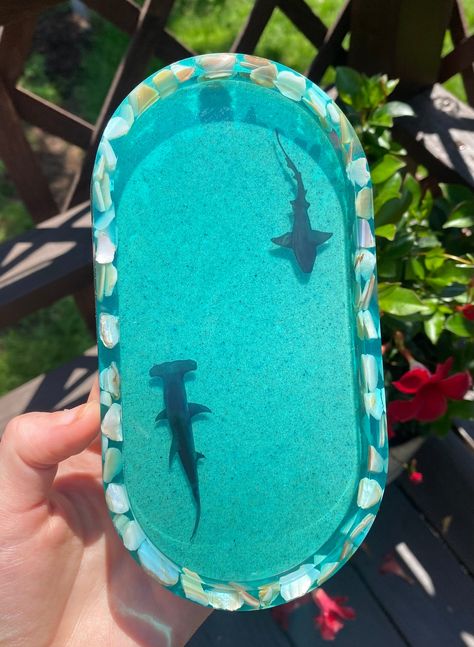 7x4in handmade oceanic shark pill-shaped tray made with real sand and crushed iridescent seashells. Can be used for rolling, crystals, jewelry, soap, etc. Available with 'normal' nurse sharks, hammerhead sharks, or one of each Please note that each piece is uniquely handmade, and may not look exactly like picture. Color and seashells placement may vary. *Sharks are printed on vinyl, not 3D Sea Room Ideas, Gifts For Shark Lovers, Shark Presents, Shark Home Decor, Shark Products, Shark Items, Shark Things, Resin Shell Tray, Ocean Resin Tray Diy