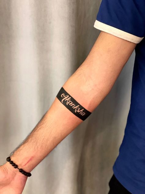 Half Sleeve Band Tattoo, Band Tattoo Designs With Name, Arm Band Tattoo With Names, Armband Tattoo With Name, Arm Band Name Tattoo, Wristband Tattoos Men, Name Band Tattoo Design, Black Band Tattoo Meaning, Tattoo Name Ideas For Men