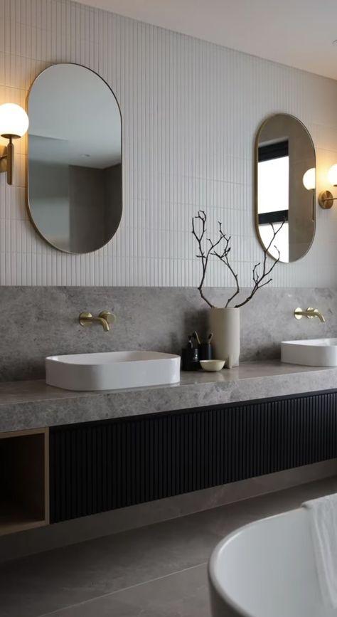 Modern Lux Bathroom, Hotel Lobby Bathroom, Dezeen Bathroom, Modern Luxe Interior Design, Contrast Bathroom, Reeded Door, Bathroom 2023, Oval Mirrors, Stone Vanity