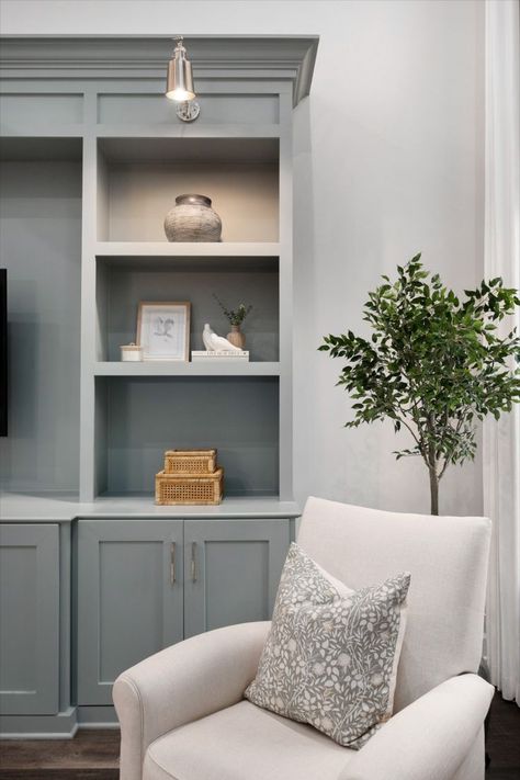 The coziest reading nook complete with blue custom built-ins for extra storage in this living room remodel. The finishing touch was the douple silver sconces for additional lighting. Built Ins With Lights, Bookshelves Lighting, Builtin Bookshelves, Bookshelf Lighting, Built In Entertainment Center, Living Room Built Ins, Custom Built Ins, Room Remodel, Living Room Remodel