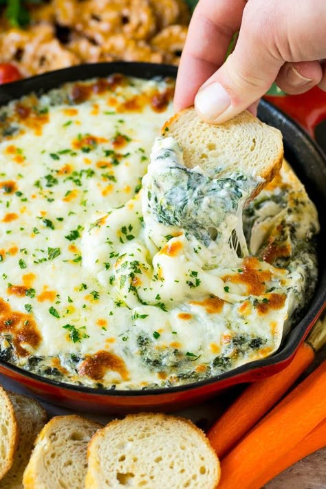 A piece of bread scooping into a pan of spinach dip. Melted Cheese Dip Recipes, Ground Beef And Fresh Spinach Recipes, Hot Cheesy Spinach Dip, Spinish Dip Recipes Knorr, Spanish Artichoke Dip, Spinish Dip Recipes, Spanish Dip Recipes, Spinish Dip, Spanish Dip