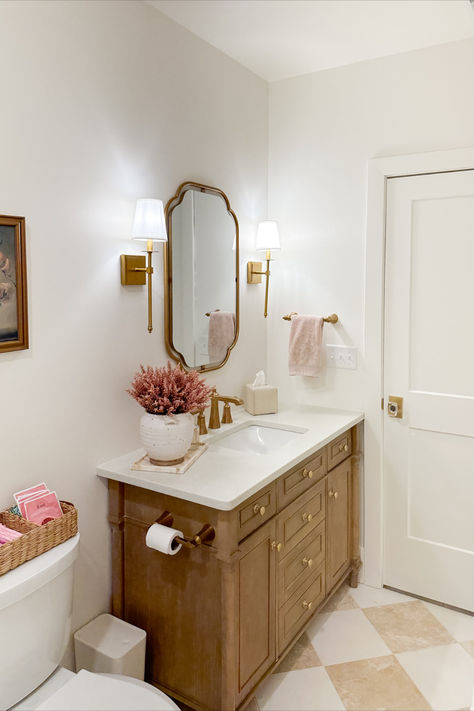 Light and bright guest bathroom with neutral wood tones, creamy whites, and pops of pink! It was important for this space to feel bright and inviting as this space does not have much natural lighting

Spring style, guest bathroom, light and bright, neutral wood tones, creamy whites, pops of pink, gold detail, wall sconce, vanity finds, neutral home, aesthetic finds, gold mirror, Wayfair, Michael’s, found it on Amazon, Target style, bathroom refresh, Grand Millennial Guest Bathroom, Pink Master Bath Ideas, Timeless Neutral Bathroom, Grand Millennial Style Bathroom, Pink And Wood Bathroom, Bathroom With Gold Hardware, Nancy Meyers Bathroom, Pink White Bathroom, Kids/guest Bathroom