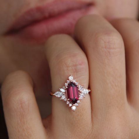 Long Hexagon Rhodolite and diamond halo Celestial Star engagement ring - Nora. D E T A I L S : ♥ Center stone shape: Elongated Hexagon  ♥ Center stone type: Rhodolite 2 carat. ♥ Accent stones: Natural diamonds, conflict-free, 0.70ct, F color, VS clarity. ♥ Gold: 14K or 18K solid gold. Yellow, white, or rose gold. ♥ Sizes: 4 - 11. Please select your wanted ring size and gold color in the drop-down menu. ♥️♥️♥️ Service ♥️ Free IGL Jewelry Certificates: including evaluation for insurance; the certi Unique Wedding Rings Ruby, Garnet Marquise Ring, Diamond And Garnet Engagement Ring, Engagement Rings Different Stones, Ruby Halo Engagement Ring, Silver Ruby Engagement Ring, Acotar Engagement Ring, Diamond And Amethyst Engagement Ring, Red Engagement Rings