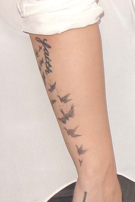 Demi Lovato Flock of Birds Forearm Tattoo | Steal Her Style Birds Forearm Tattoo, Flock Of Birds Tattoo, Letter G Tattoo, Demi Lovato Tattoos, Tattoos On Wrist, Bird Flock, Bird Tattoos Arm, Bird Tattoo Wrist, G Tattoo