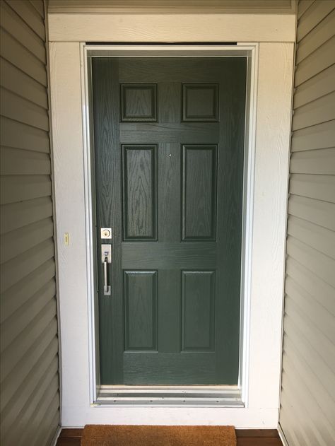 Behr - pastoral green - PPU10-20. front door with cream trim and tan siding. Love how this brought depth to our house! Behr Pastoral Green, Tan House Green Door, Behr Pastoral, Front Door Paint Colors For Tan House, Dark Green House Exterior, Tan Siding, Door And Trim Paint, Home Depot Doors, Green House Exterior