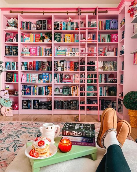 This pretty in pink library has had a hauntingly cute makeover 👻🎀 @theintrovertedition's home library is the stuff of dreams at the best of times, but the halloween decor has made it extra cozy. #halloweendecor #homelibrary #pinkdecor #librarygoals #myrealhome Books Library Home, Dream Rooms With Books, Pink Built In Bookcase, In Home Libraries, Cute Library Room, Pink Bookshelf Aesthetic, Pink Home Library, Pink Library Room, Pink Library Aesthetic