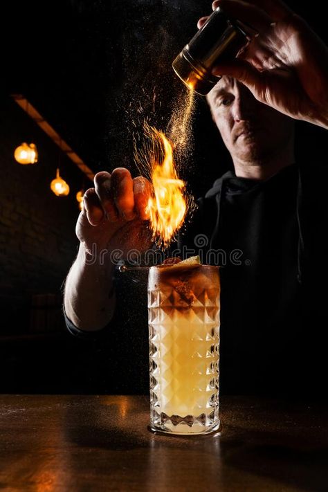 Burning cinnamon in cocktail. Bartender pours and fire burns cinnamon in alcoholic cocktail at a bar. Bartender is royalty free stock photo Bartender Photoshoot, Bartenders Photography, Bar Photoshoot, Magic Bars, Bar Stock, Alcoholic Cocktails, Cocktails Bar, A Bar, Photoshoot Ideas