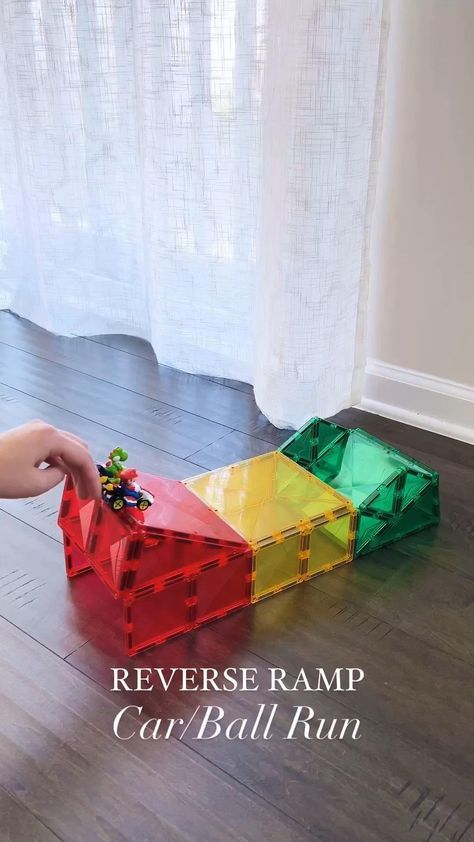 Switch things up with this reverse ramp design! @pandamommyteacher showcases that you don’t need a large Connetix Tile collection to have epic STEAM fun! To make this reverse ramp you need: ⭐ 3 big squares ⭐ 12 small squares ⭐ 4 isosceles triangles ⭐ 6 equilateral triangles Some top tips from Alice-  1. Build the back side first and close the back for support during building. Once you are done building, remove the two bottom pieces on the back to allow the cars/balls to come out. 2. Use light Magnetic Building Toys, Magnet Activities, Ramp Design, Kids Activities At Home, Tiles Ideas, Baby Play Activities, Magnetic Tiles, Daycare Activities, Toddler Play