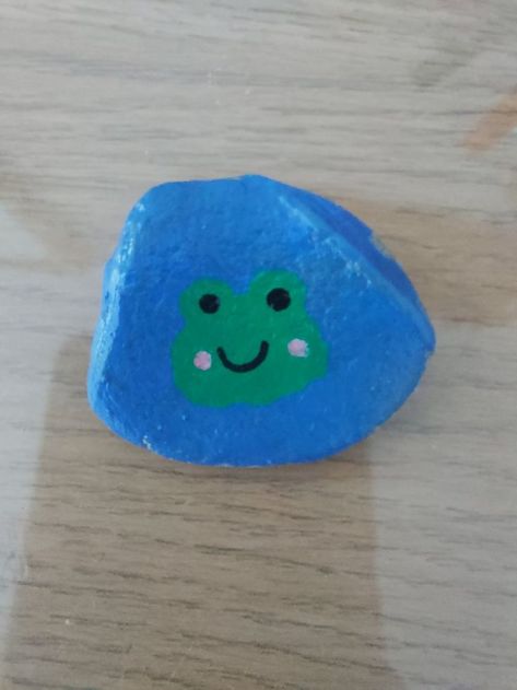 Colbalt Blue background with a cartoon frog head, painted with POSCA pens. Rock Collected from a Cornish Beach. Kindness Rock, Painted Rock, Rock Artist. Blue Rock Painting Ideas, Painted Rocks Aesthetic, Posca Pen Ideas, Frog Painted Rocks, Painting 2023, Frog Rock, Cornish Beaches, Posca Pens, Cartoon Frog