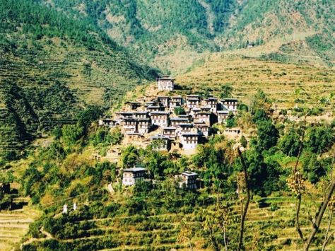 Notice in this hillside village in Bhutan that the roof eaves are all aligned with the terraces of the landscape. THer are not sharp roofs projecting up or gable ends facing outward.  I think this makes a very pleasing composition of houses.  All very similar but each varied. Hillside Architecture, Roof Eaves, Hillside Village, Bhutan, The Roof, The Landscape, Terrace, Roof, Composition