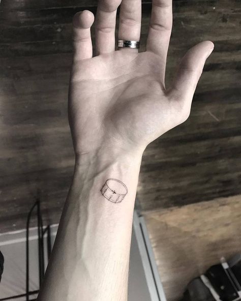 Minimalist drum tattoo on the inner wrist. Simple Drum Tattoo, Small Drum Tattoo, Drum Tatoos, Drum Tattoo Ideas For Women, Percussion Tattoo, Drum Set Tattoo, Drummer Tattoo Ideas, Drums Tattoo Ideas, Drum Tattoo Ideas