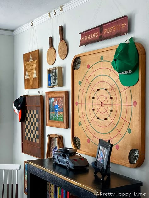 vintage game gallery wall small updates in the kids' bedrooms Vintage Game Boards Decor, Old Game Boards Upcycle, Cabin Game Room Ideas, Game Room Wall Decor Ideas, Funky Game Room, Vintage Game Decor, Home Board Game Room, Vintage Dart Board, Game Room Gallery Wall