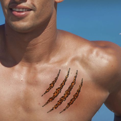 leopard print scratches tattoo on chest Scratches Tattoo, Chest Tattoo Bear, Tattoo In Chest, Tiger Claw Tattoo, Thoughtful Tattoos, Skin Tear Tattoo, Scratch Tattoo, Cheetah Print Tattoos, Family Name Tattoos