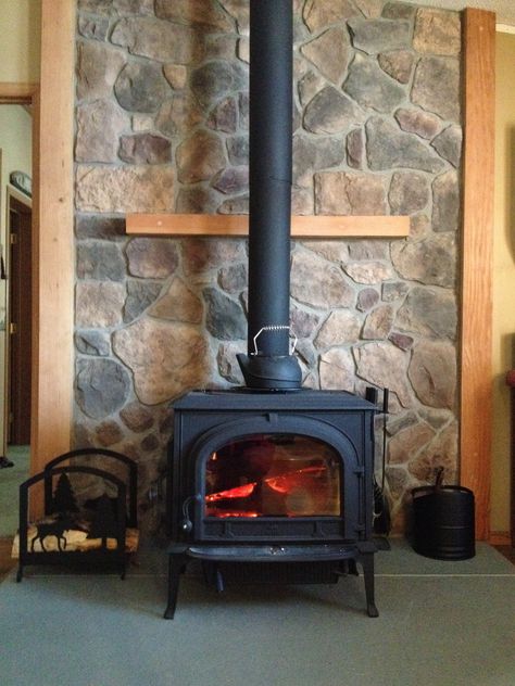 Wood stove with cultured stone. Stone Wall Wood Stove, Wood Stove With Stone Surround, Stone Around Woodstove, Stone Wall Behind Wood Stove, Wood Stove Stone Wall, Stone Behind Wood Stove, Woodstove Surrounds Stone, Stone Wood Stove, Hearth Wood Stove