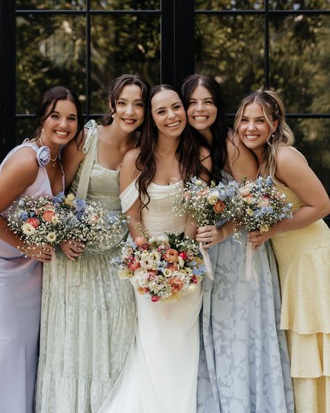 Cami & Nathan’s gorgeous spring garden party wedding was a vibrant celebration filled with mismatched bridesmaids’ dresses, an array of spring colors, and elegant floral touches. @infinityroseeventsco helped create a charming and unforgettable atmosphere for their special day. 🌷💖✨⁠ •⁠ •⁠ Wed Society | Oklahoma FEATURED vendors:⁠ Wedding Planner: @infinityroseeventsco⁠ Entertainment: @redlinedjok⁠ Decor & Rentals: @partyprorents⁠ Floral: @considertheliliesbyaubrey⁠ •⁠ •⁠ // Photo:⁠ @hannahvand... Floral Bridesmaid Dresses With Groomsmen, Wedding Party Mismatched Dresses, Wildflower Wedding Bridesmaid Dresses, 4 Bridesmaids Mismatched, Spring Mismatched Bridesmaid Dresses, Mismatched Floral Bridesmaid Dresses, Spring Wedding Bridal Party, Floral Mismatched Bridesmaid Dresses, Garden Party Bridesmaids