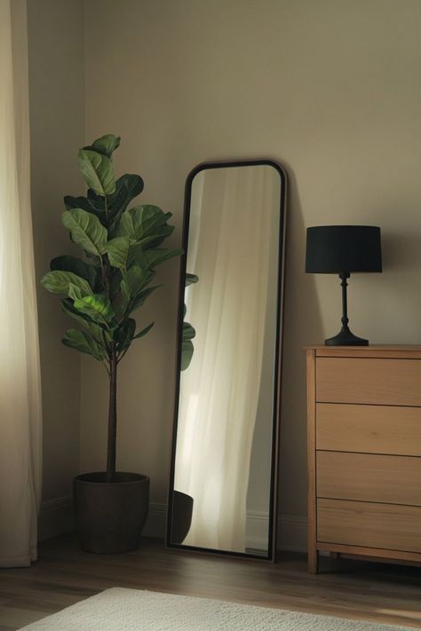 Wondering how mirrors can make your bedroom feel bigger? The trick is in how you place them! A well-placed full-length mirror, like the one shown here, can reflect light and create the illusion of more space. Avoid positioning mirrors directly facing your bed to keep things serene, and instead, place them in corners or angled spots for maximum effect. It’s a simple yet powerful way to make your bedroom look bigger! Make Bedroom Look Bigger, Mirror Ideas Bedroom, Length Mirror In Bedroom, Wall Mirror Ideas Bedroom, Big Mirror In Bedroom, Wall Mirror Ideas, Full Length Mirror In Bedroom, Mirror Hack, Mirror Placement