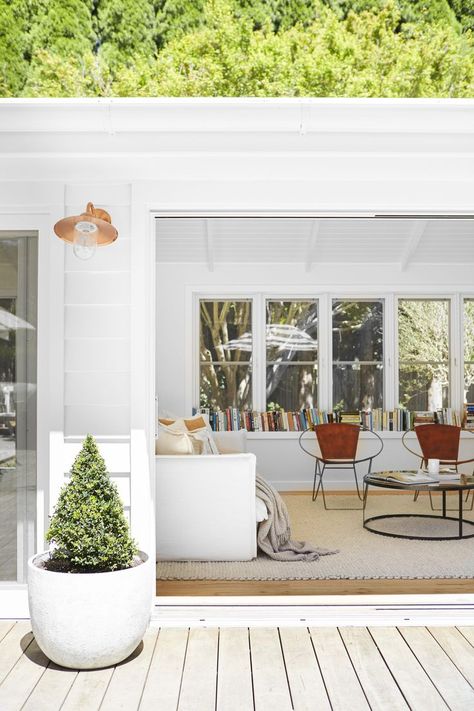 This sunroom has banks of windows all the way around to borrow from the surrounding garden. The round metal frame and leather seats of a pair of armchairs invite the use of the window sill library, while a potted topiary is centred beneath a copper outside wall light. Enclosed Sunroom Ideas, Sunroom Design Ideas, Enclosed Sunroom, Small Utility Room, Historical Interior, Sunroom Ideas, Country Manor, Sunroom Designs, Study Nook