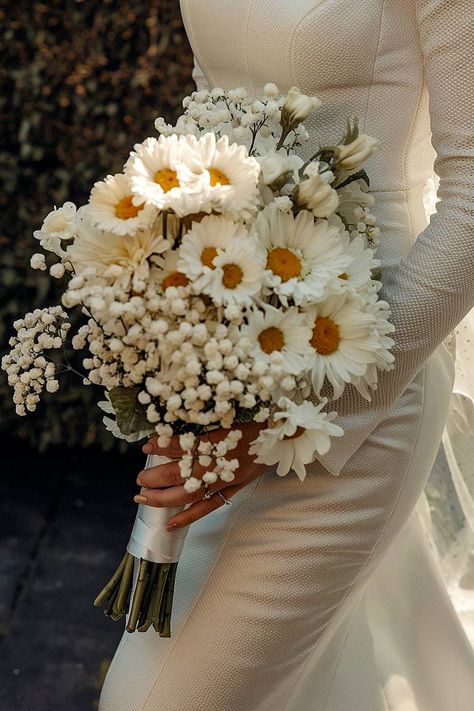 A daisy bridal bouquet with baby’s breath accents. Daisy Flower Wedding Decor, Baby Breaths Bouquet, Daisy Flower Bouquet Aesthetic, Bridal Flowers Bouquet Rustic, Bride Flower Bouquet Rustic, Sunflower Bouquet Ideas, Wedding Bouquets With Daisies, Winter Floral Bouquet, Babys Breath Bridesmaids Bouquet