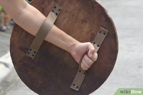 How to Make a Wooden Shield: 15 Steps (with Pictures) - wikiHow Buckler Shield, Greek Shield, Escudo Viking, Round Shield, Wooden Shield, Viking Shield, Shield Maiden, Shield Design, Wood Toys