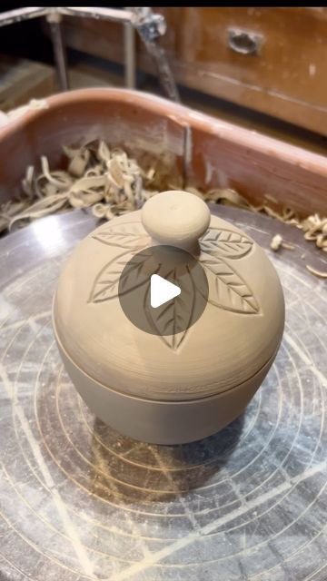 Paula Clegg on Instagram: "Have you ever made a closed form lidded container?!   Here is my process:  I throw a cylinder and then bring in the top to make the knob and use a tool to make a wide groove where I want to lid to separate.   Once the form is leather hard, I cut the top off and trim the base and lid to get them to fit together. And voila! You have a lidded container using only one piece of clay and no measuring!   This lidded container is going to be decorated to look like a strawberry 🍓 and will be available at the Afton Strawberry Festival, June 22 & 23.   Stay tuned for a look at the finished product!   #potterywheelvideos #potteryvideos #ceramics #clay #clayartist #satisfyingvideos" Pottery Container With Lid, Ceramic Lidded Containers, Ceramic Boxes With Lid, Pottery Canister Sets, Clay Containers, Pottery Handles, Strawberry Festival, Pottery Videos, Pottery Handbuilding