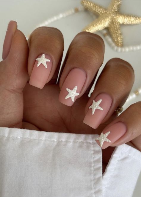 In this blog post, we’ve curated 34 elegant, playful, and utterly chic white nail ideas that will transform your fingertips into works of art. Whether you’re a fan of minimalist sophistication, intricate floral details, or a sprinkle of glitter, there’s a white nail design here to suit every style and mood. From glitter star party nails to delicate white geometric designs, you're sure to find a white nail design you love! White Nails Star Design, White Nails With Accent Nail, White Starfish Nails, Star Fish Nail Design, Starfish On Nails, Summer Nail Inspo Starfish, Matte Nail Art, White Nail Designs, Party Nails