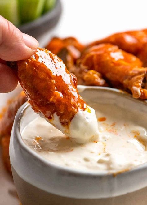 Close up dipping buffalo wing into blue cheese dip Oven Baked Buffalo Wings, Buffalo Chicken Dip Oven, Baked Buffalo Wings, Wings Recipe Buffalo, Buffalo Wing, Baked Wings, Blue Cheese Dip, Blue Cheese Sauce, Crispy Chicken Wings