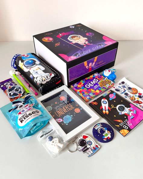 🚀Space-themed Rakhi Hamper for Lil Bro👨‍🚀 To the 🌜& 🔙 with love! Our rakhi hamper is out of this world, just like your younger brother. 🎁🧿 This beautiful box comes with the following goodies- • Pencil Box • Diary • Customizable Frame • 2-in-1 Rakhi • Keychain • Badge • Pen & Pencil • Eraser • Hand Band • Stickers • Hershey’s Kisses • Cadbury Gems • Crispello Price: ₹1999/- + shipping DM us to place your order 💌 No COD [Gift hampers, rakhi gifts, rakhi hampers, rakhi gifts2024, rakhi f... Cadbury Gems, Rakhi Hampers, Hand Band, Lil Bro, Band Stickers, Younger Brother, Pencil Box, Pencil Eraser, Pencil Boxes