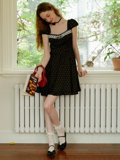 This product, the Cest Polka Dot Petite Dress, effortlessly blends vintage charm with contemporary style. The dress features a playful polka dot pattern, creating a fun and classic look. Its fitted bodice and flared skirt design make it a flattering choice for various body types. - This dress is adorned with a timeless polka dot pattern, adding a touch of classic elegance.- The fitted bodice and flared skirt design create a flattering and feminine silhouette.- It is made from lightweight and breathable fabric, ensuring comfort for all-day wear.- The dress features delicate lace detailing along the neckline, enhancing its vintage appeal.- A handmade Cali medal decoration has been attached to the lower right side of the front panel to add a unique point of interest. Twee Dresses, Vintage Feminine Outfits, Black And White Polka Dot Dress, Dots Skirt Outfit, Girly Vintage Outfits, Vintage Outfits Dress, Clairo Concert, Polka Dot Skirt Outfit, Elegant Feminine Outfits