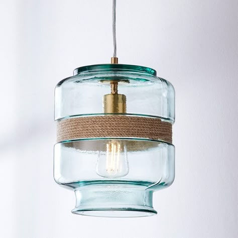 Enhancing its natural appeal, a rustic rope band elegantly wraps around the middle of this fixture, adding a touch of organic charm and further accentuating its sustainable nature. The interplay between the recycled glass from Spain and the earthy texture of the rope creates a captivating visual contrast. It is an ideal choice for creating a coastal oasis in your home or bringing a touch of seaside charm to any space. This fixture is assembled by hand in our Richmond, Virginia production facilit Nautical Bathroom Light Fixtures, Lake House Lighting Ideas, Coastal Entryway Lighting, Lake House Lighting Fixtures, Lake House Lighting, Coastal Lighting Ideas, Modern Coastal Lighting, Seaside Farmhouse, Coastal Pendant Lights