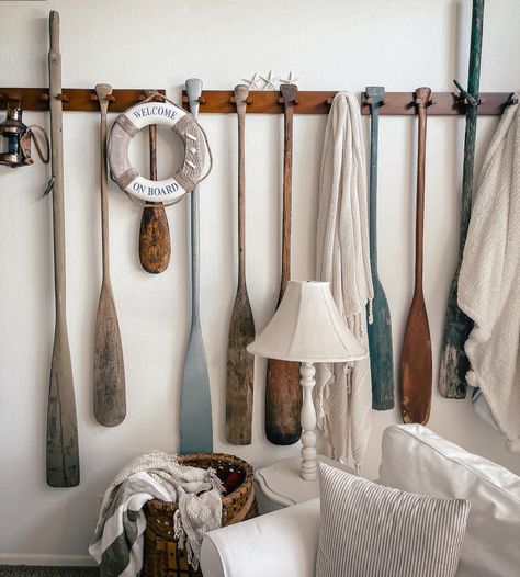 A display of vintage oars and paddle can instantly transform your beach house living room. Wooden Oars Decor, Oar Decor, Wooden Oars, California Beach House, Wooden Whale, Beach House Living Room, Entry Bench, House Living Room, White Couches