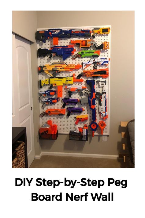 Wall-mounted pegboard displaying an organized collection of colorful Nerf guns and related accessories. Nerf Storage Ideas Peg Board, Peg Board Nerf Wall Diy, Kids Pegboard Ideas, Nurf Wall, Pegboard Nerf Wall, Nerf Armory Wall, Nerf Wall Boy Rooms, Nerf Pegboard Wall, Nerf Wall Storage