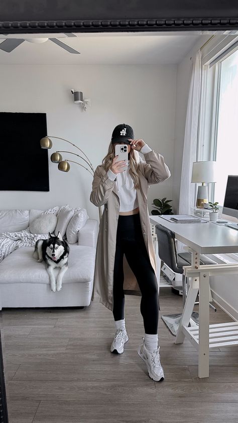 Athleisure Outfits Trench Coat, Athleisure With Trench Coat, Trench Coat Hoody Outfit, Trench Coat Baseball Hat Outfit, Sporty Trench Coat Outfit, Trench Coat With Sweatpants, Trench And Hoodie Outfit, Trench Coat Sweatshirt Outfit, Trench Coat Airport Outfit