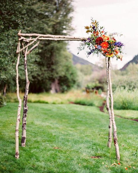 Unkempt Willow Branch Wedding Arch with Pink and Orange Flowers Branch Arch Wedding, Outdoor Wedding Arch, Simple Wedding Arch, Gazebo Wedding Decorations, Wooden Wedding Arches, Gazebo Decorations, Wedding Arches Outdoors, Diy Wedding Arch, Wedding Branches