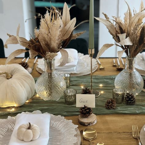 Create an unforgettable dining experience with our Autumn Luxe Tablescape. This elegantly crafted set provides a touch of sophistication with its sage green and white colour combination. Impress your family and friends with this beautiful tablescape; perfect for any autumn-themed occasion. Decor Set x1 Sage Green Cheesecloth Runner x3 Gold Taper Candlesticks x3 Sage Green Taper Candles x2 Cream and Gold Pumpkinsx2 Crystal Cut Glass Ball Vasesx2 Natural Rustic Posiesx5 Gold Mottled T-Lights x1 Se Sage Pumpkin Decor, Sage Thanksgiving Decor, Sage Green And White Fall Decor, Neutral Fall Party Decor, Tablescape For Thanksgiving, Green And Cream Fall Decor, Cream And Gold Table Setting, Sage Green Thanksgiving Table, White Pumpkin Tablescape