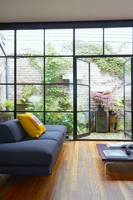 In this contemporary grey living room, an outdoor area was created by shortening the roof and adding a glass wall. (houseandgarden.co.uk) Mews House, Contemporary Room, Patio Interior, Design Exterior, City Garden, House Roof, Living Room Diy, Living Room Grey, Glass Doors