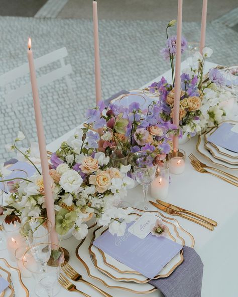 A SPRING SOIRÉE 💜 Now featured in @hellomaymagazine Immerse yourself in the exquisite opulence of our regal Lilac Soirée, a harmonious blend of fanciful charm and sophistication. Surrender to the enchanting shades of peach and lilac, complemented elegantly by blush-coloured vintage taper candles. Here is where unforgettable events are born. #LilacSoiree Event stylist: @lnr_events_ Photographer: @emmahawkins_photography Florist: @stateofnaturefloral Tableware: @eventmerchantco Linen: ... Lilac Colour Scheme Wedding, Lilac Blue Wedding Theme, Lilac And Peach Wedding Decor, Lilac Aesthetic Wedding, Purple Color Schemes Wedding, Lilac Wedding Aesthetic, Gold And Lilac Wedding, Lilac Tablescape, Lilac Table Setting