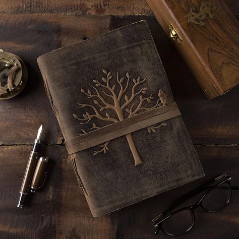 EXQUISITE & UNIQUE EMBOSSED TREE DESIGN: The Leather-Bound Journal is made from thick Dark Brown Water Buffalo Leather which is Soft & Supple to the touch. We have taken extra to make sure that the emboss is perfect in every piece. The leather is tanned with a special oil that will allow you to create your own distressed style if you fold the leather. Our Journals are proudly made by Gifted Artisans and use the best genuine leather that is available. Leather Bound Notebook, Brown Leather Journal, Vintage Leather Journals, Leather Sketchbook, Leather Diary, Leather Bound Journal, Paper Leaves, Drawing Sketching, Antique Paper