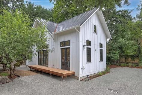 Board and batten siding and a standing seam metal roof give this 1199 square foot 1 bedroom ADU (Accessory Dwelling Unit) New American appeal. Three sets of French doors open to the open concept interior which gives you a C-shaped kitchen and an open living room. The bedroom is on the left side and has its own bathroom. Laundry is located just outside the bedroom in a private closet. Upstairs, a loft overlooks the open space below. With a full bath with shower, its the perfect sleepover spot..
#tinyhouse #minimalistliving #smallspaces #sustainableliving #tinyhouselife 2 Bedroom House Plans With Loft, 2 Bedroom Cabin With Loft Floor Plans, Square Home Floor Plans, Casita Guest House Floor Plans, 800sq Ft House Plans, Tuff Shed Tiny House Floor Plans, 2 Bedroom With Loft House Plans, Two Bedroom House Plans Open Floor, 2 Bedroom Floor Plans Open Concept