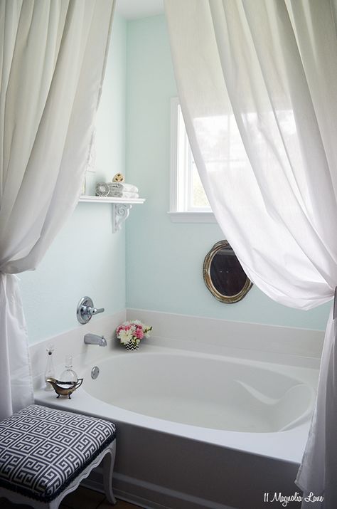 beautiful bath! i love the little things sitting out (flowers, the glass holders + the white curtains really soften it and the old gold mirror ads a bit of chic to it :) also like the aqua colored walls. Tub Ideas, Spa Like Bathroom, Bathroom Tub, Garden Tub, Bathroom Windows, Trendy Bathroom, Bathroom Spa, White Rooms, Grey Bathrooms